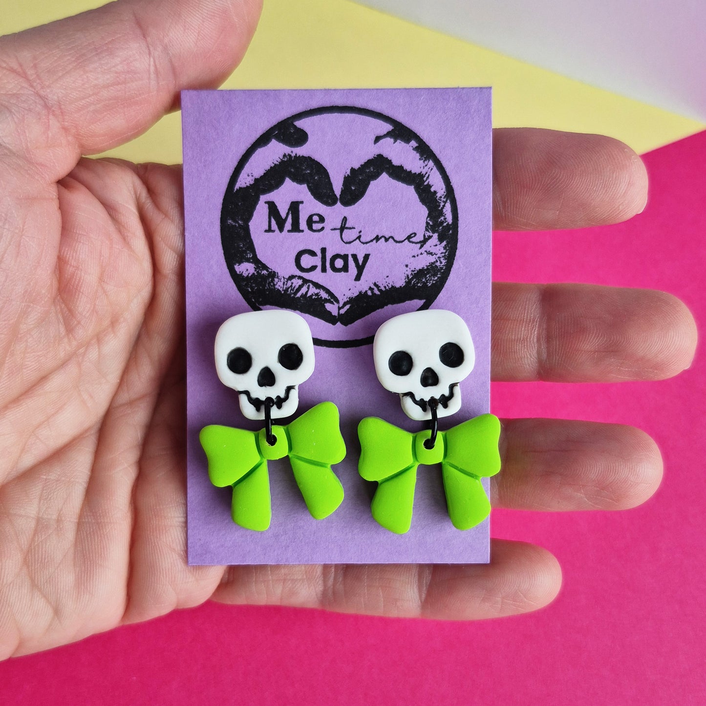 Cute halloween dangle earrings, skull + bow, white + lime green
