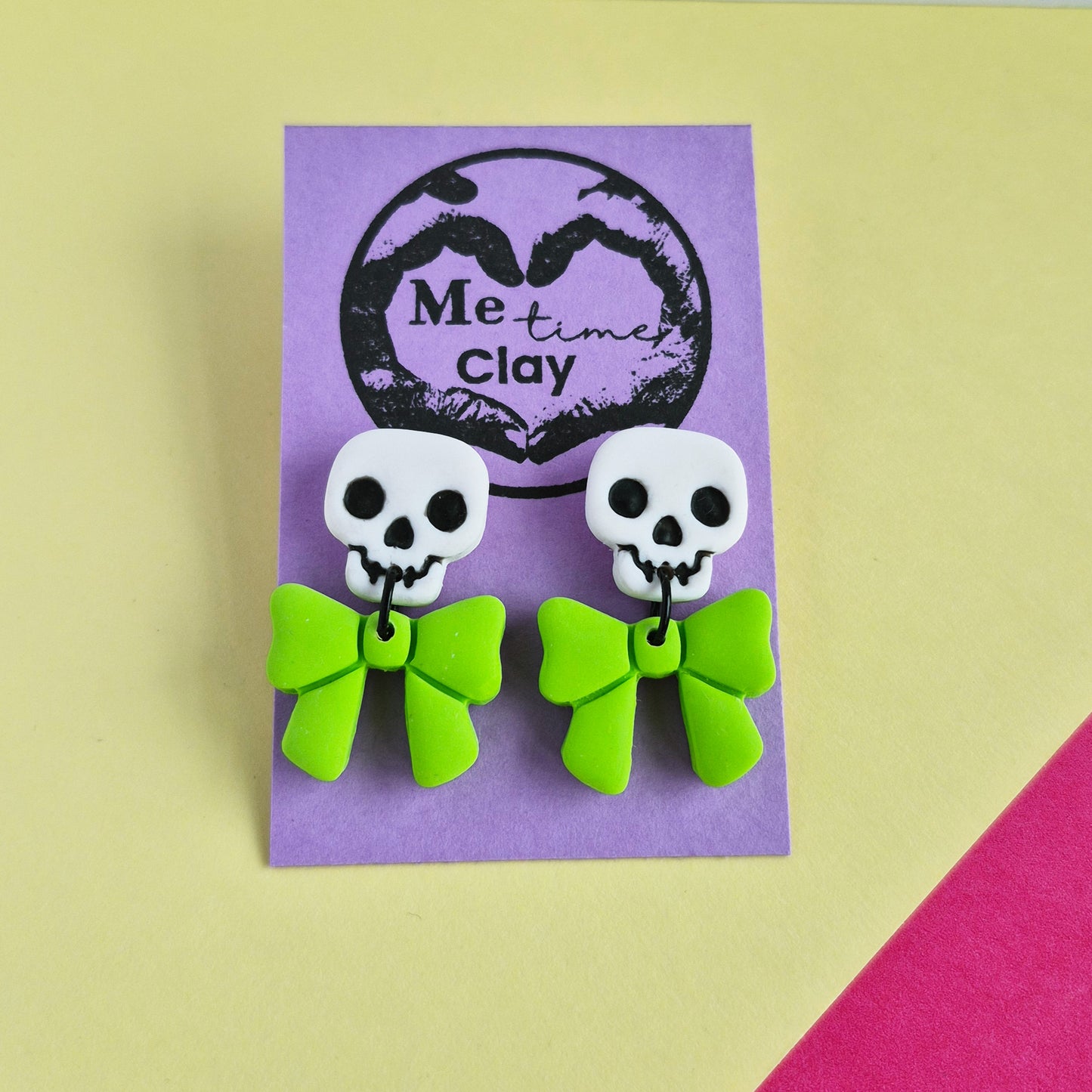Cute halloween dangle earrings, skull + bow, white + lime green