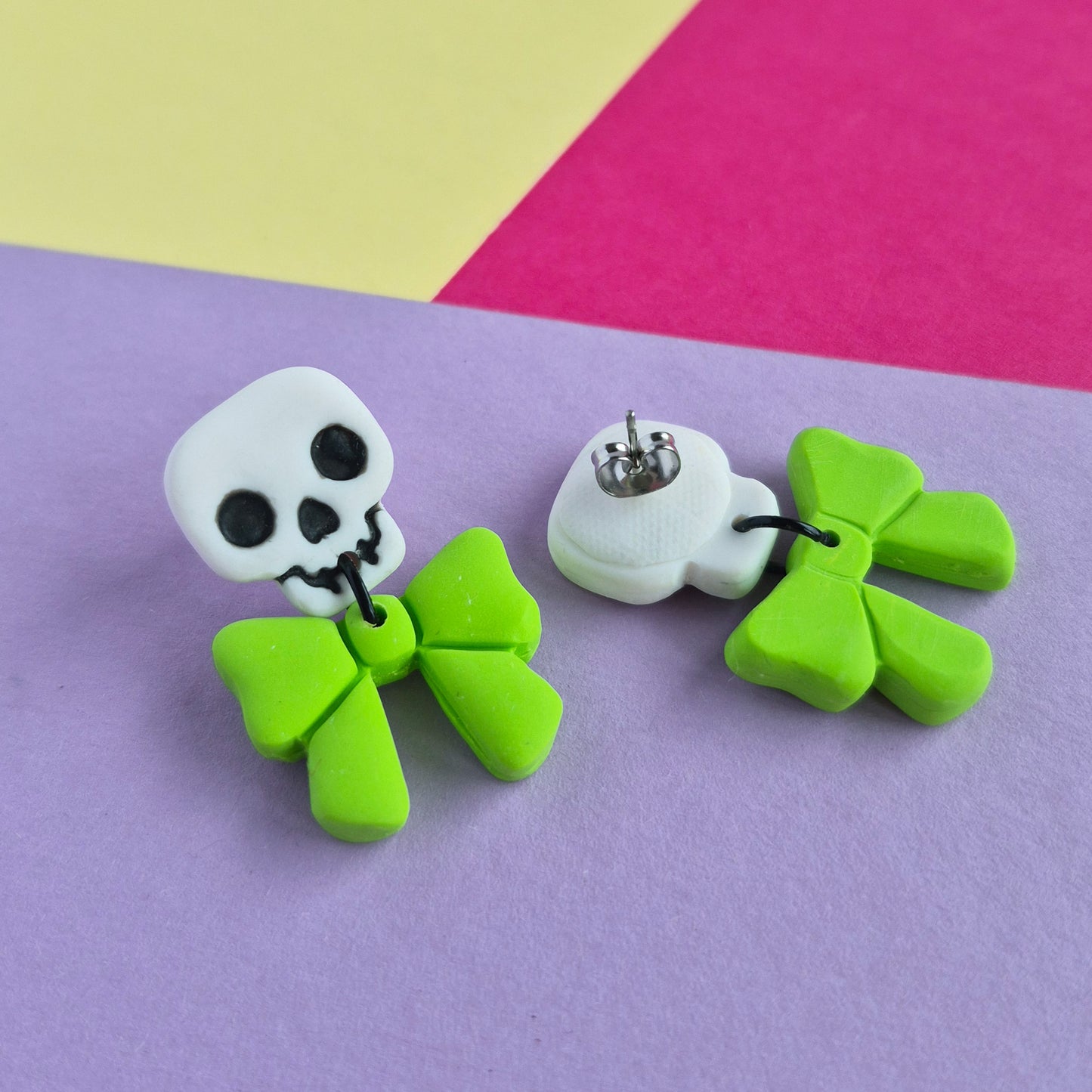Cute halloween dangle earrings, skull + bow, white + lime green