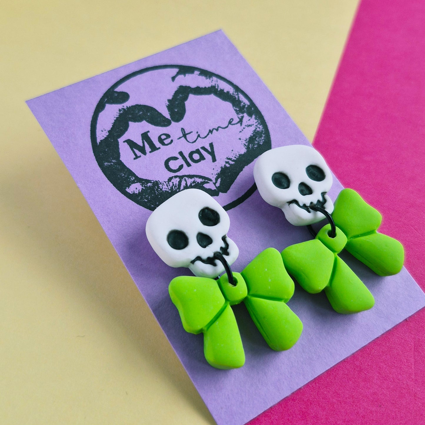 Cute halloween dangle earrings, skull + bow, white + lime green