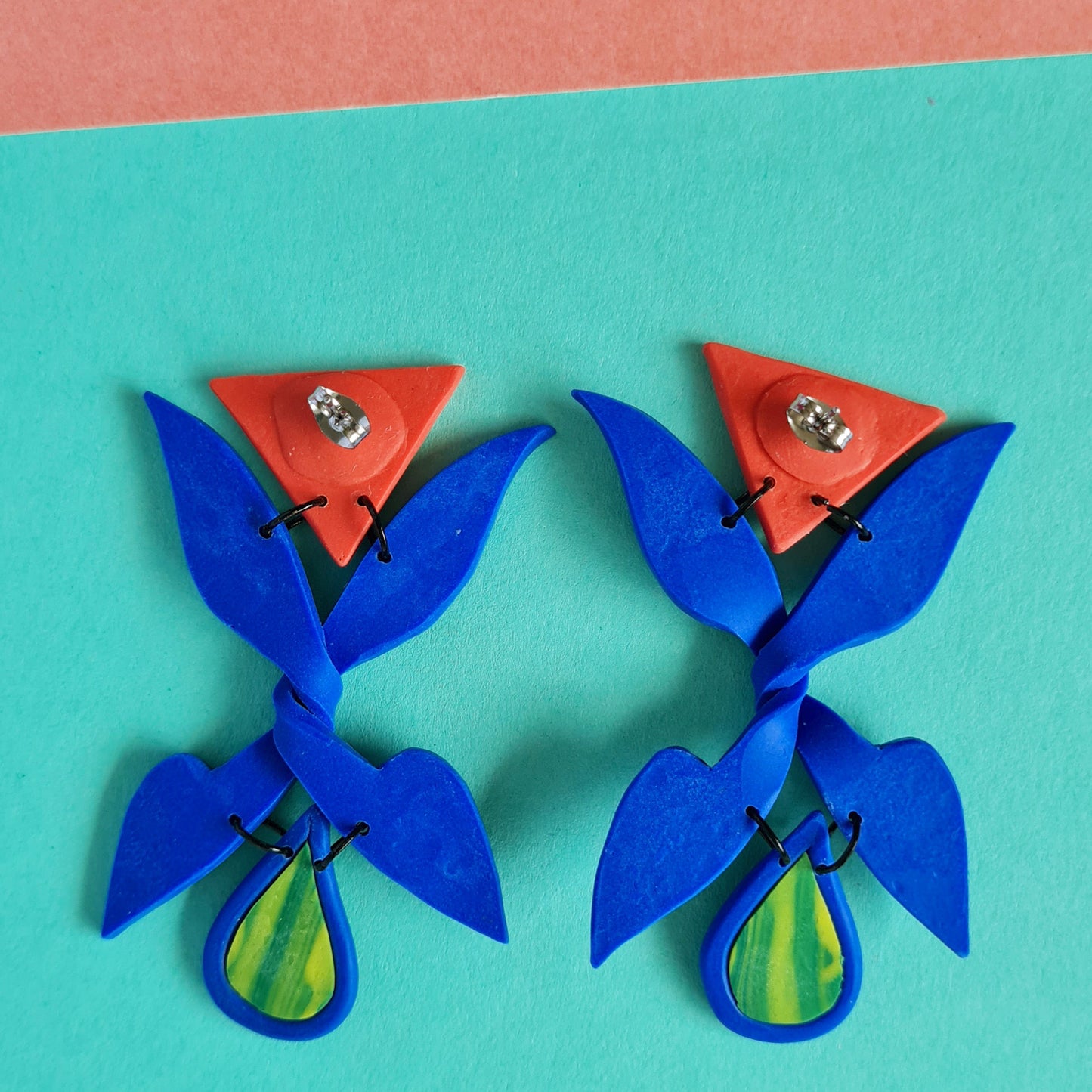 Trick me blue X shape triangle dangle earrings