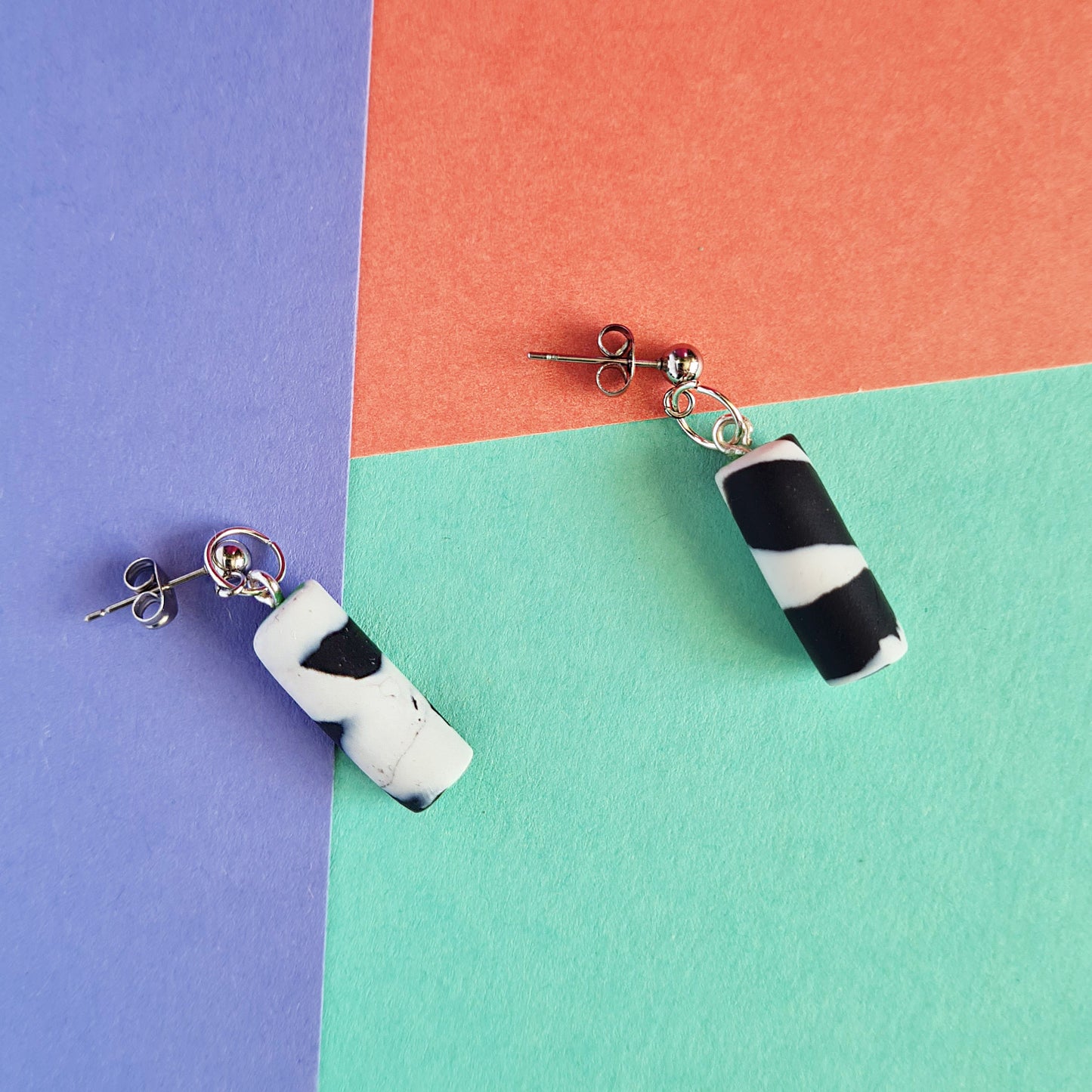 Black & white spotted cylinder dangle earrings