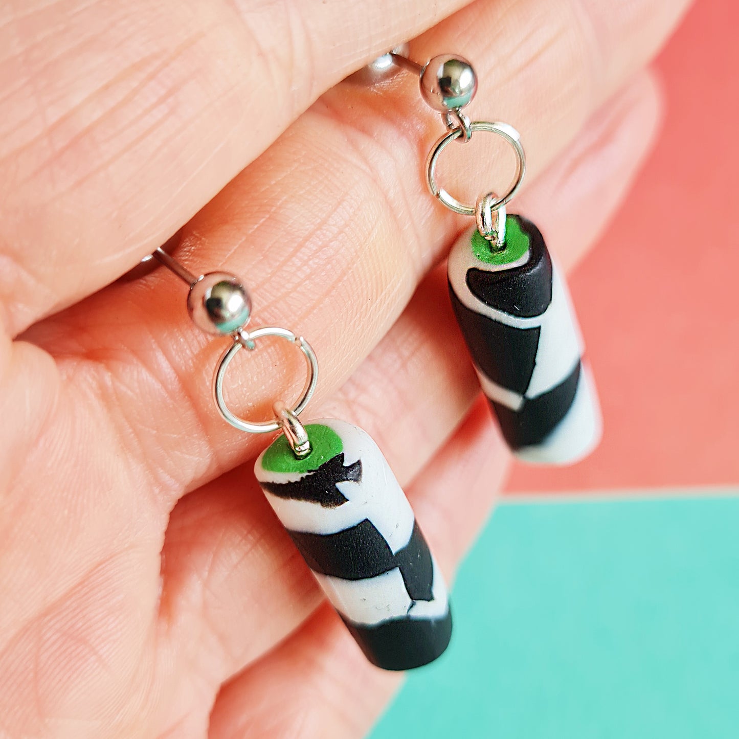 Black & white spotted cylinder dangle earrings