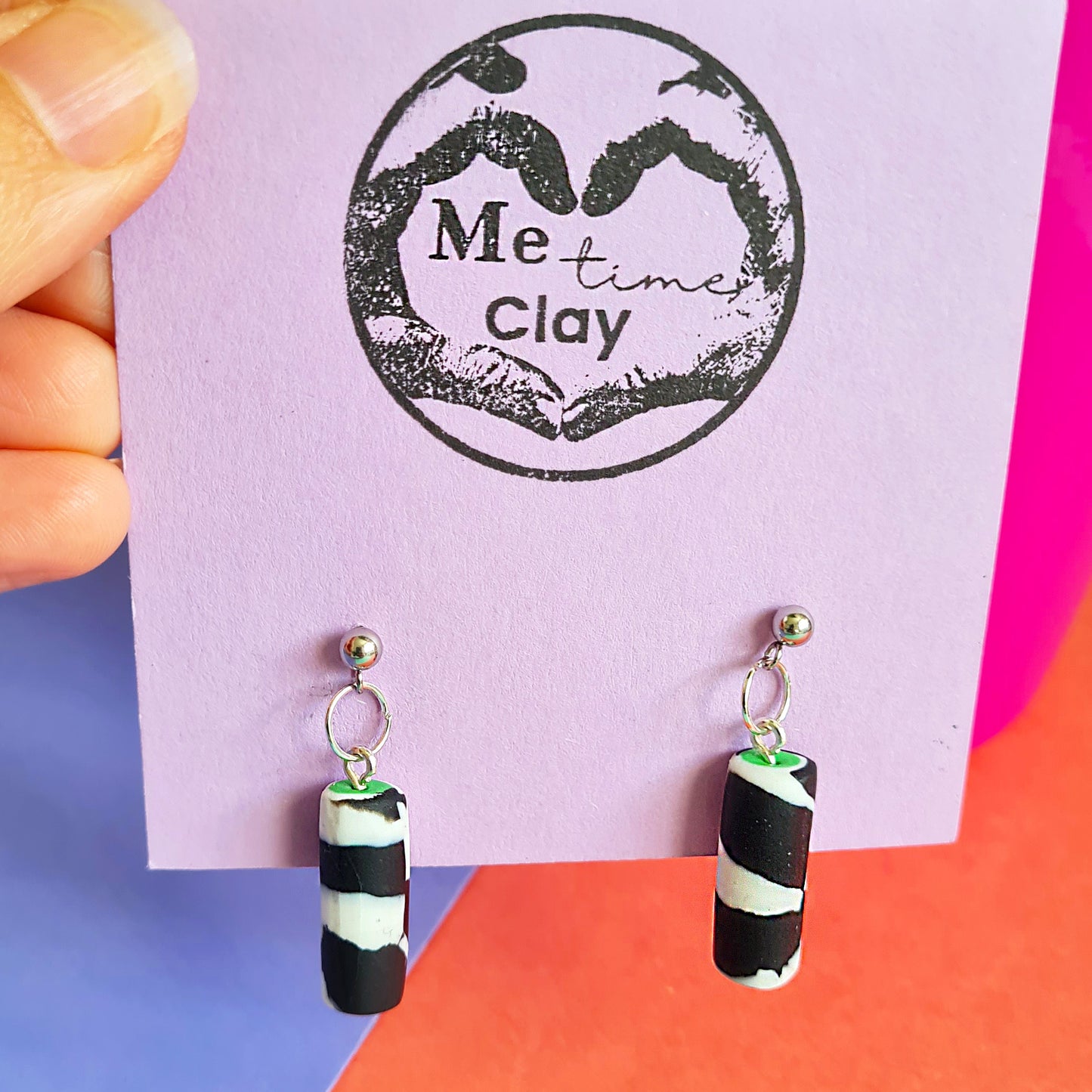 Black & white spotted cylinder dangle earrings