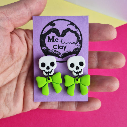 Cute halloween dangle earrings, skull + bow, white + lime green